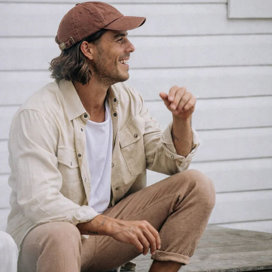 Man in brown cap on step 