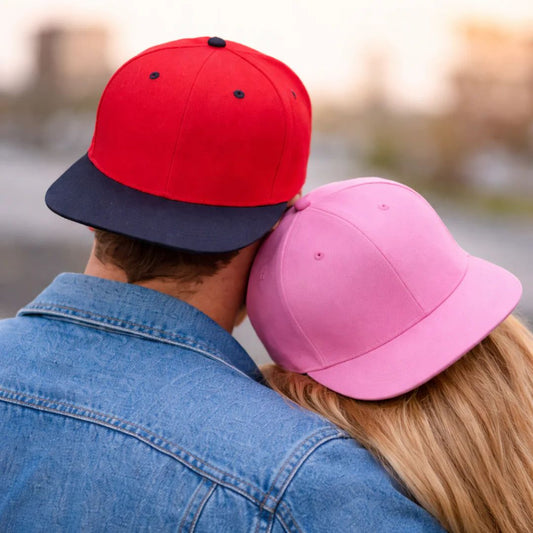 Man and woman in snapback caps 